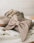 leather bows featured in sand