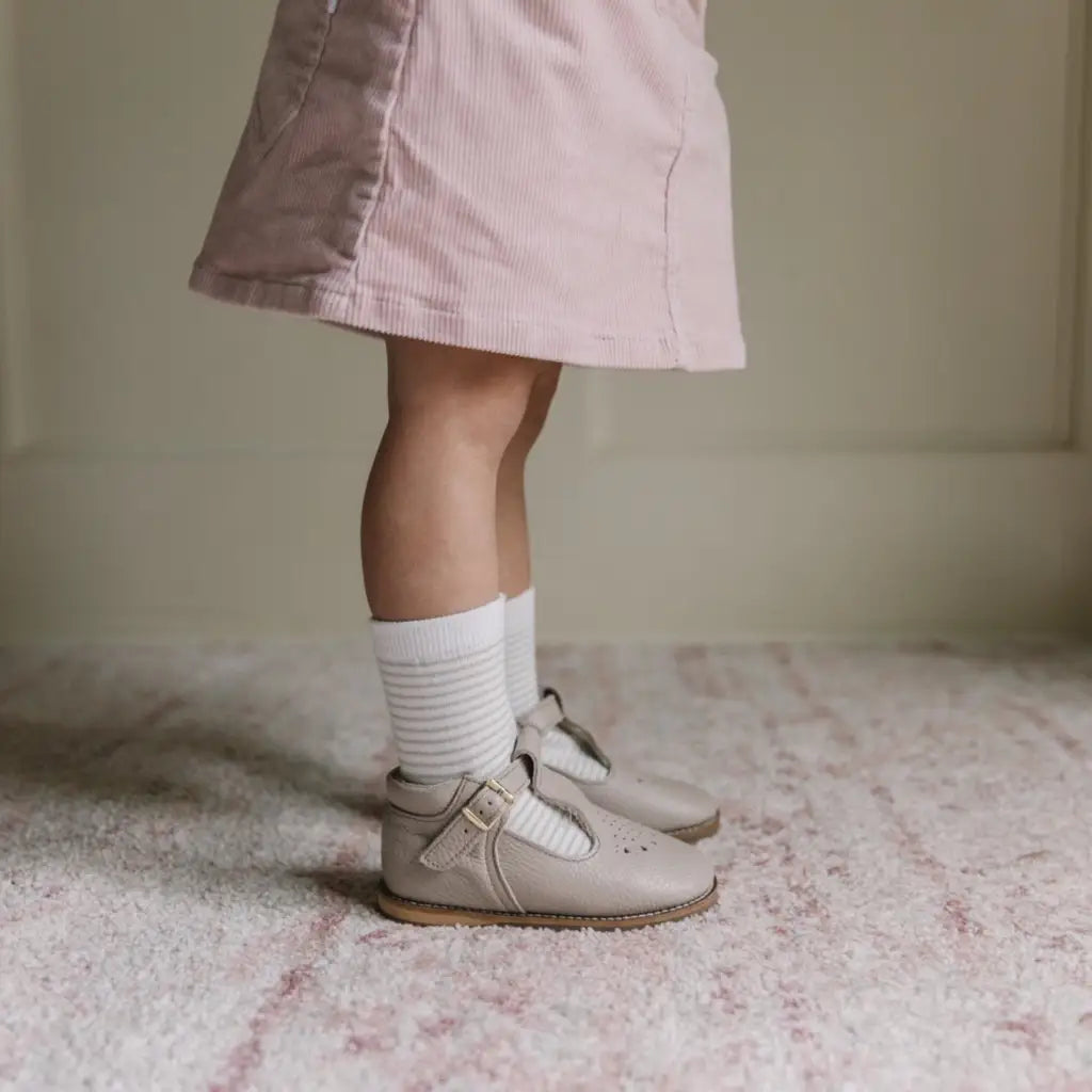 model wearing greta leather t-strap in color sand
