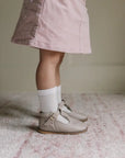 model wearing greta leather t-strap in color sand