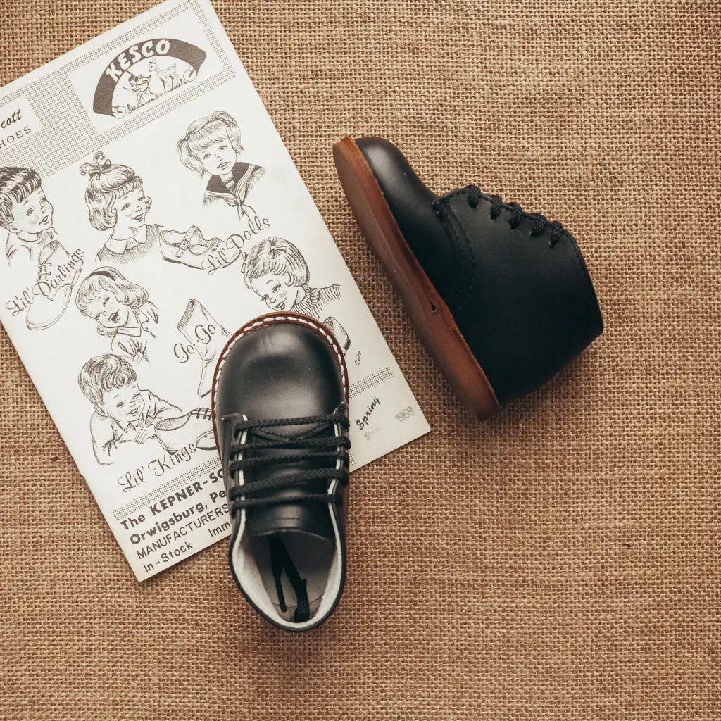 black leather first walker, brown sole, black laces, beige inside