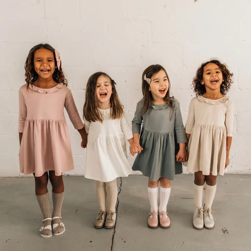 models wearing leather shoes and bows featured in colors fog, sand, peony, and terrazzo
