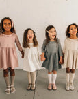 models wearing leather shoes and bows featured in colors fog, sand, peony, and terrazzo