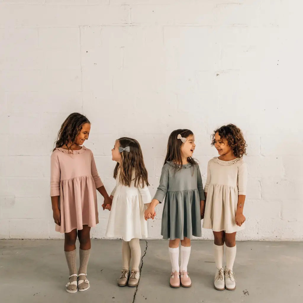 models wearing leather shoes and bows featured in colors fog, sand, peony, and terrazzo