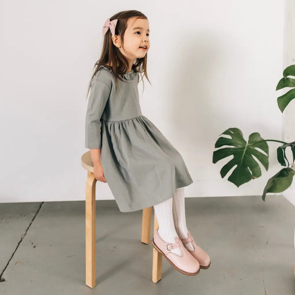 model wearing leather bow and shoes featured in color peony