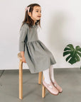 model wearing leather bow and shoes featured in color peony