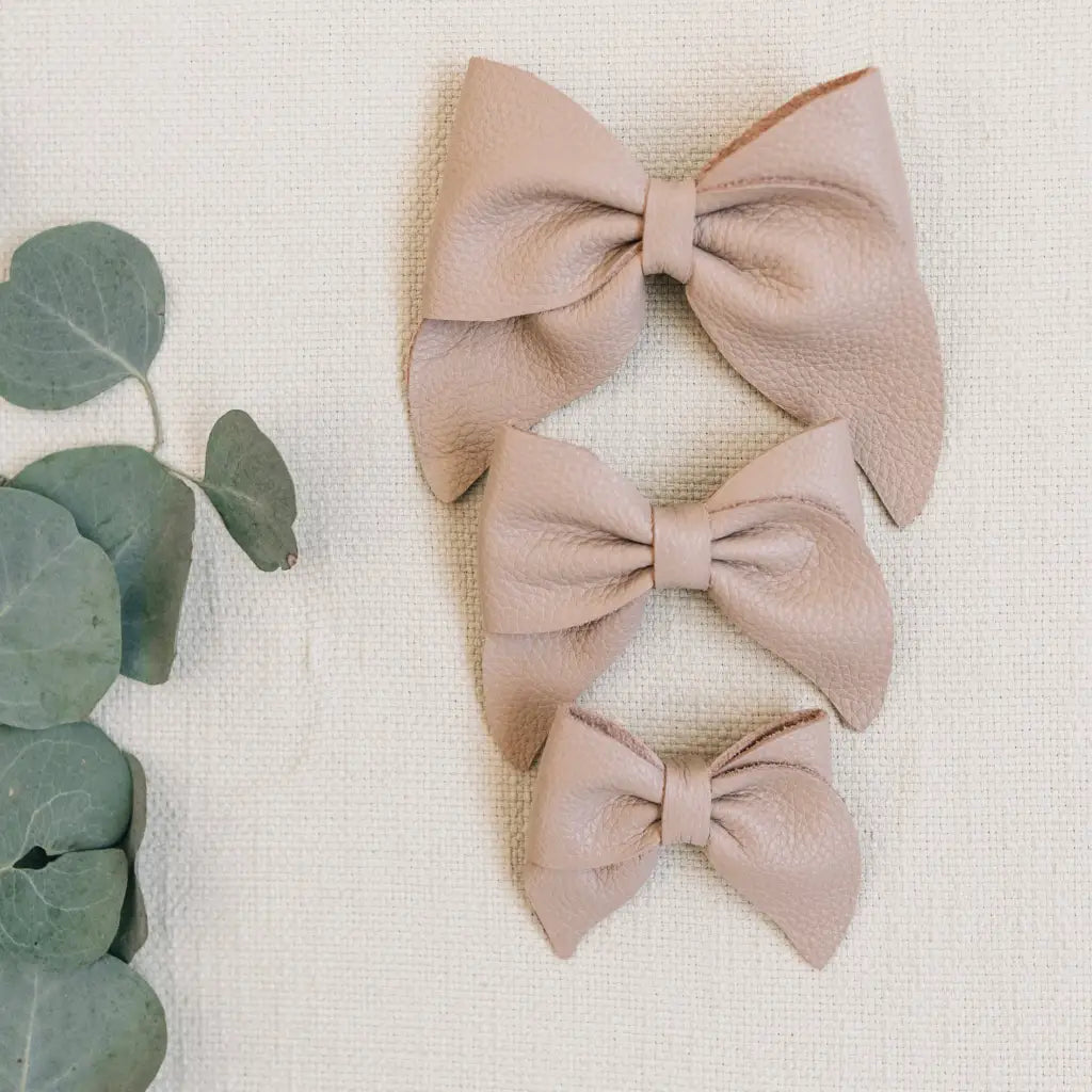 leather bows featured in color sand