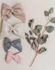 leathers bows featured in color sand, fog, heron, and peony