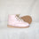 Pair of pink shoes on a white fabric background