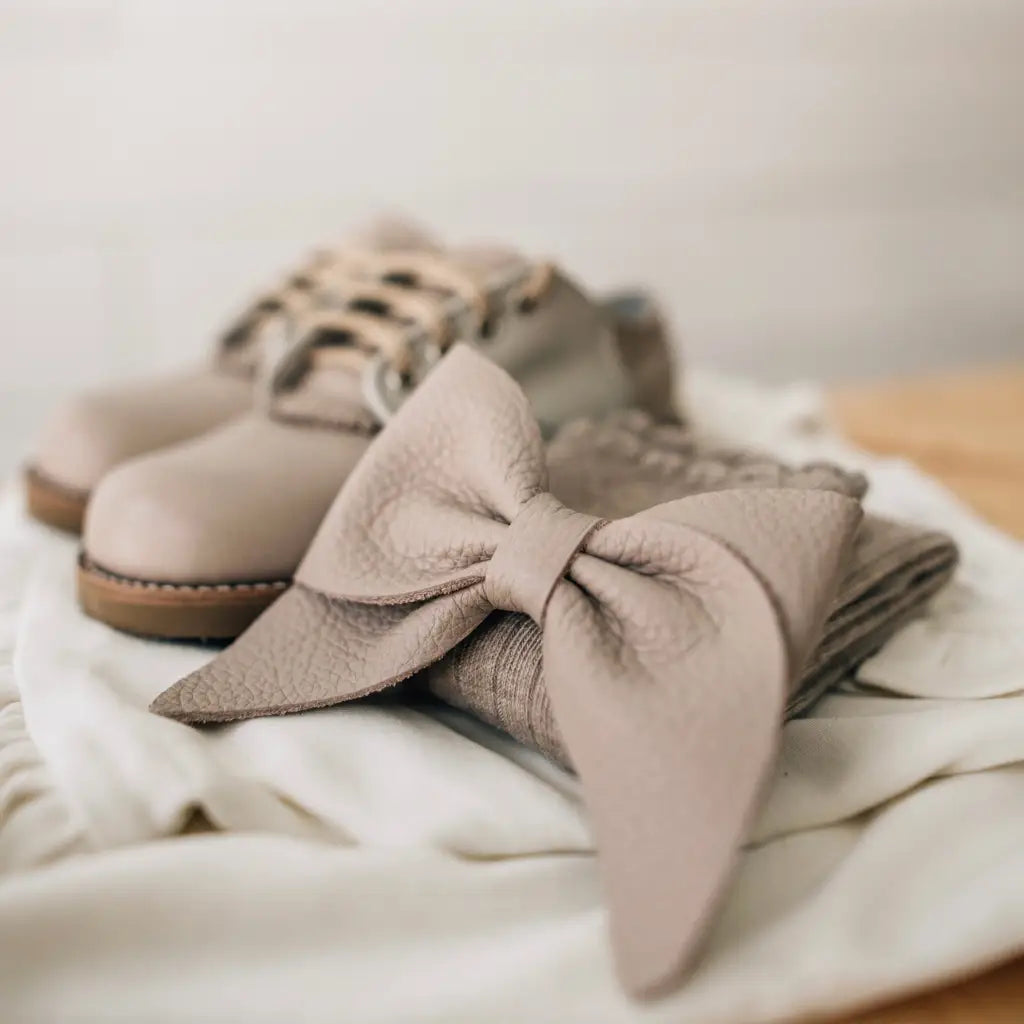 leather bows featured in sand