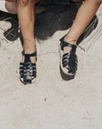 navy leather sandal with beige sole