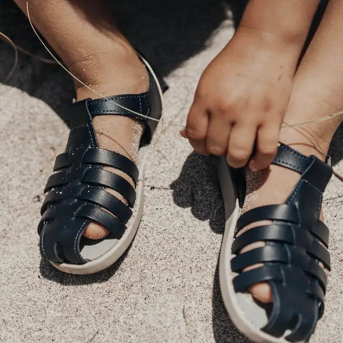 navy leather sandal with beige sole