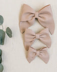 leather bows in sand