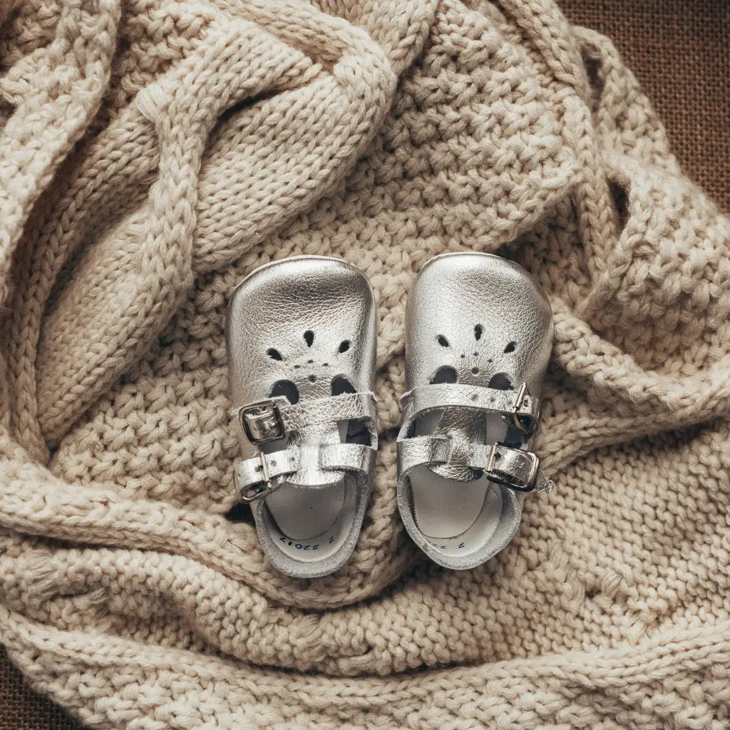 silver leather crib shoes, two straps, petal shaped holes, white insides