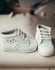 white leather first walker, boots, white laces, cutout hearts on outer side of shoe, white sole